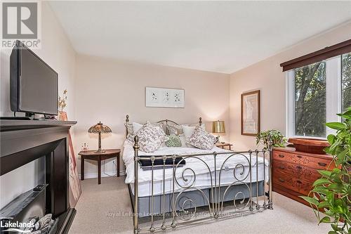 201 - 34 Bayfield Street, Meaford, ON - Indoor Photo Showing Bedroom With Fireplace