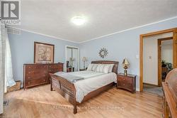 Bedroom with light hardwood / wood-style floors and a closet - 