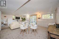 Carpeted dining room featuring brick wall - 