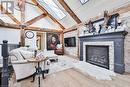 Living room with beamed ceiling, a stone fireplace, light wood-type flooring, and high vaulted ceiling - 1486 Kenmuir Avenue, Mississauga, ON  - Indoor Photo Showing Living Room With Fireplace 