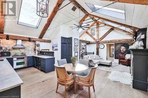 Dining area with sink, beamed ceiling, high vaulted ceiling, ceiling fan with notable chandelier, and light wood-type flooring - 1486 Kenmuir Avenue, Mississauga, ON - Indoor