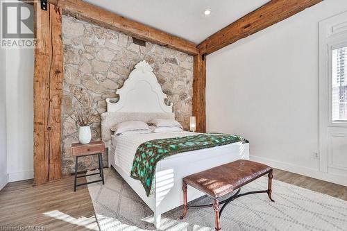 Bedroom featuring beam ceiling, a barn door, and light hardwood / wood-style floors - 1486 Kenmuir Avenue, Mississauga, ON - Indoor Photo Showing Bedroom