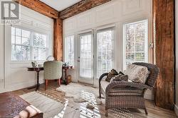 Home office with beam ceiling and light hardwood / wood-style flooring - 