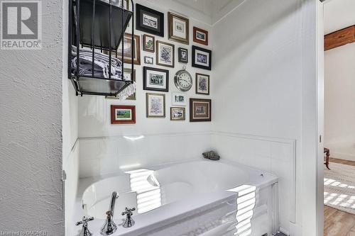 Bathroom featuring hardwood / wood-style floors and a bathtub - 1486 Kenmuir Avenue, Mississauga, ON - Indoor Photo Showing Bathroom