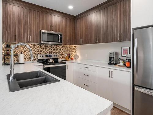 201-6544 Metral Dr, Nanaimo, BC - Indoor Photo Showing Kitchen With Double Sink With Upgraded Kitchen