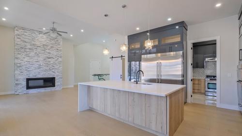 937 Royal Troon Lane, Kelowna, BC - Indoor Photo Showing Kitchen With Fireplace With Upgraded Kitchen