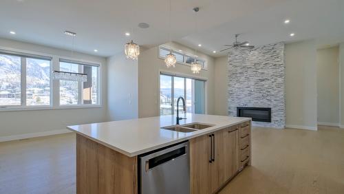 937 Royal Troon Lane, Kelowna, BC - Indoor Photo Showing Kitchen With Fireplace With Double Sink