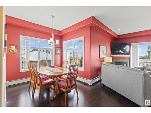 #467 11517 Ellerslie Rd Sw, Edmonton, AB - Indoor Photo Showing Dining Room With Fireplace