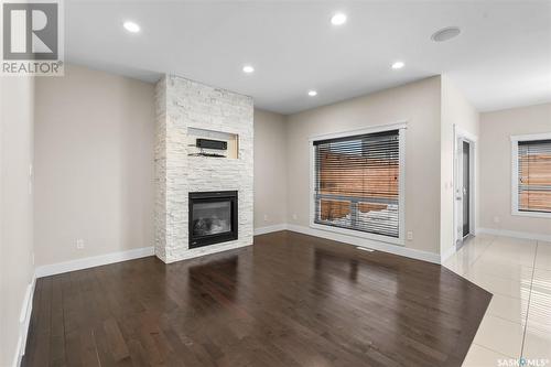 526 Baltzan Bay, Saskatoon, SK - Indoor Photo Showing Other Room With Fireplace