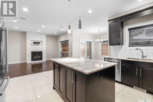 526 Baltzan Bay, Saskatoon, SK - Indoor Photo Showing Kitchen With Fireplace With Double Sink With Upgraded Kitchen