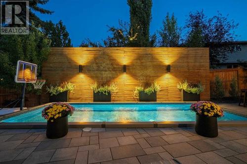 Privacy screen with lighting - 432 Strathcona Mews Sw, Calgary, AB - Outdoor With In Ground Pool