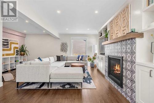 Lower level family room - 432 Strathcona Mews Sw, Calgary, AB - Indoor Photo Showing Living Room With Fireplace