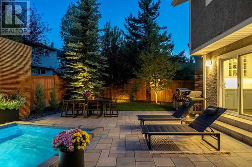 Modern patio stone with lounge chairs - 432 Strathcona Mews Sw, Calgary, AB - Outdoor With In Ground Pool With Deck Patio Veranda