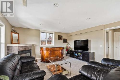 69 Evansbrooke Park Nw, Calgary, AB - Indoor Photo Showing Living Room With Fireplace