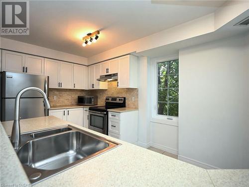 2301 Parkhaven Boulevard Unit# 204, Oakville, ON - Indoor Photo Showing Kitchen With Stainless Steel Kitchen With Double Sink