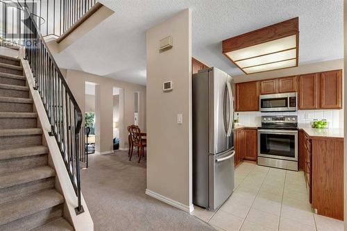 Open Staircase to Top Level - 153 Woodglen Grove Sw, Calgary, AB - Indoor Photo Showing Other Room