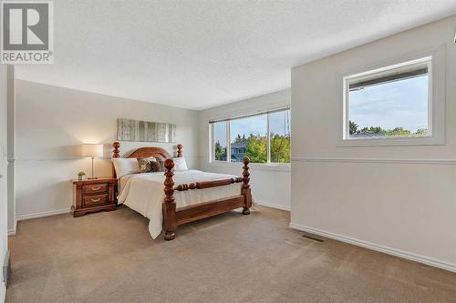 Primary Suite - 153 Woodglen Grove Sw, Calgary, AB - Indoor Photo Showing Bedroom