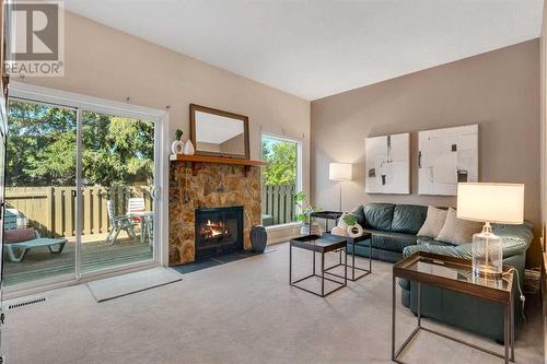 Large Living Room with high ceilings and charming wood fireplace - 153 Woodglen Grove Sw, Calgary, AB - Indoor Photo Showing Living Room With Fireplace