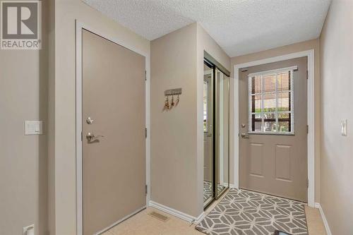 Entry way leads into attached single garage - 153 Woodglen Grove Sw, Calgary, AB - Indoor Photo Showing Other Room