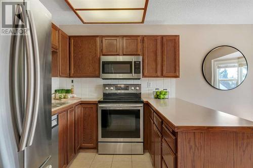 Ample Counter Space - 153 Woodglen Grove Sw, Calgary, AB - Indoor Photo Showing Kitchen With Stainless Steel Kitchen