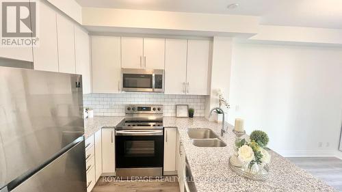 334 - 128 Grovewood Common, Oakville, ON - Indoor Photo Showing Kitchen With Stainless Steel Kitchen With Double Sink With Upgraded Kitchen