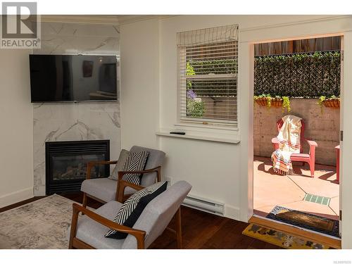 Main living space opens directly onto outdoor patio, expanding living space. - 2 1146 Richardson St, Victoria, BC - Indoor Photo Showing Living Room With Fireplace