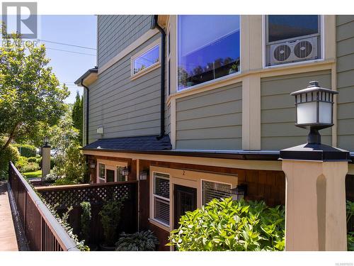 View of property exterior from common walkway on quiet side of property. - 2 1146 Richardson St, Victoria, BC - Outdoor With Exterior