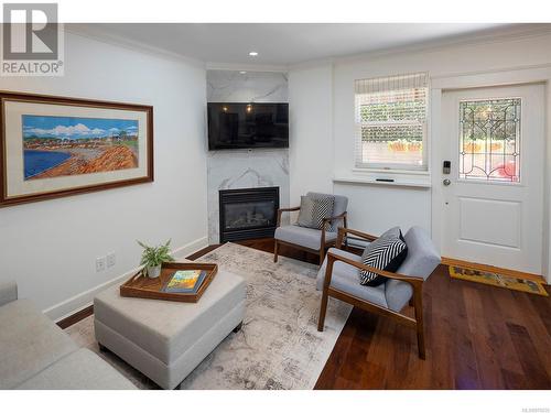 Another view of the living room with walnut floors and a gas fireplace. - 2 1146 Richardson St, Victoria, BC - Indoor Photo Showing Living Room With Fireplace