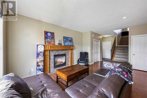 24 Copperstone Place Se, Calgary, AB - Indoor Photo Showing Living Room With Fireplace