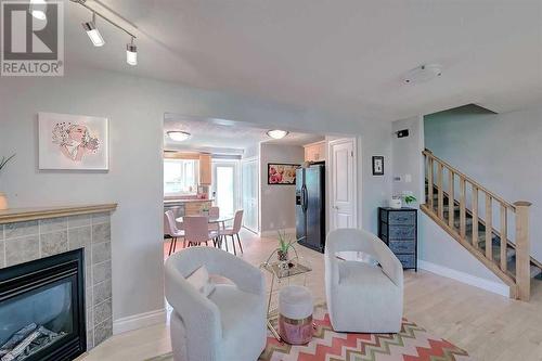 Tiled gas fireplace with corner mantle - 2417 53 Avenue Sw, Calgary, AB - Indoor Photo Showing Living Room With Fireplace