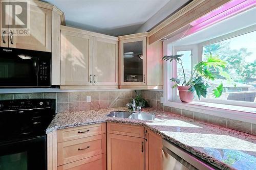 Fabulous bay window. Your plants will be delighted! - 2417 53 Avenue Sw, Calgary, AB - Indoor Photo Showing Kitchen With Double Sink