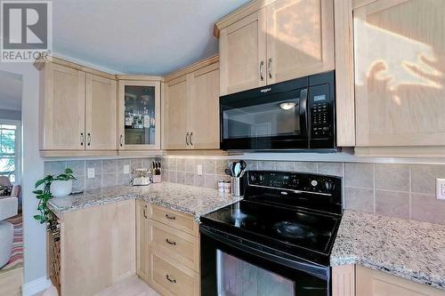 Electric stove with over the range microwave - 2417 53 Avenue Sw, Calgary, AB - Indoor Photo Showing Kitchen