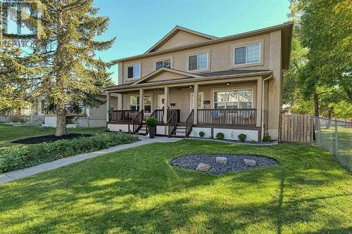 Handsome stucco exterior with country-style front veranda - 2417 53 Avenue Sw, Calgary, AB - Outdoor With Deck Patio Veranda With Facade