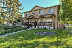 Handsome stucco exterior with country-style front veranda - 