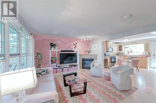 A calm and inviting space you'll be proud to show off! - 2417 53 Avenue Sw, Calgary, AB - Indoor Photo Showing Living Room With Fireplace