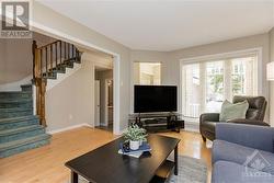 The main floor features a contemporary open-concept design and stunning maple hardwood floors. - 