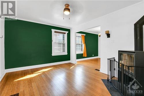 Living room featuring a trendy Stûv woodstove - 120 Queen Mary Street, Ottawa, ON - Indoor Photo Showing Other Room