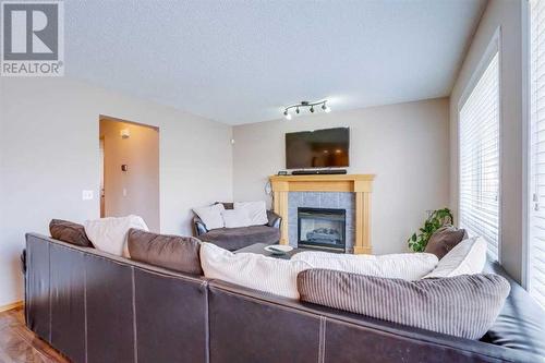 205 Coral Springs Close Ne, Calgary, AB - Indoor Photo Showing Living Room With Fireplace