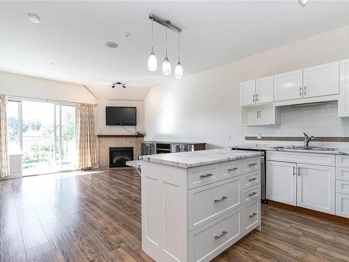 405-650 Berwick Rd, Qualicum Beach, BC - Indoor Photo Showing Kitchen With Fireplace With Double Sink