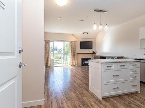 405-650 Berwick Rd, Qualicum Beach, BC - Indoor Photo Showing Kitchen With Fireplace