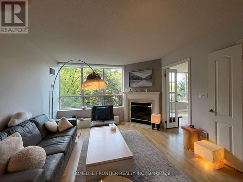 411 - 1 Ripley Avenue, Toronto (High Park-Swansea), ON - Indoor Photo Showing Living Room With Fireplace