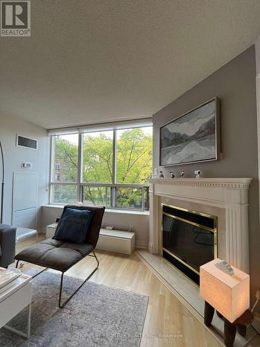 411 - 1 Ripley Avenue, Toronto (High Park-Swansea), ON - Indoor Photo Showing Living Room With Fireplace