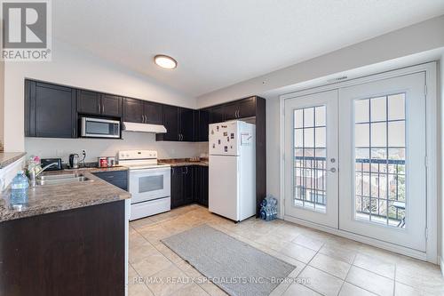 412 - 1350 Main Street E, Milton (Dempsey), ON - Indoor Photo Showing Kitchen With Double Sink