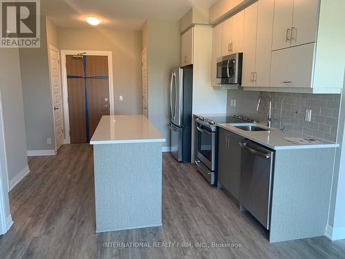 520 - 128 Grovewood Common, Oakville (Uptown Core), ON - Indoor Photo Showing Kitchen With Stainless Steel Kitchen With Upgraded Kitchen