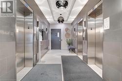 Corridor featuring light tile patterned floors and elevator - 