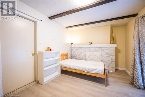 Bedroom featuring beam ceiling, light hardwood / wood-style flooring, and a textured ceiling - 212 Westcourt Place, Waterloo, ON - Indoor Photo Showing Bedroom