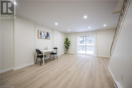 Living area featuring a baseboard radiator and light hardwood / wood-style flooring - 212 Westcourt Place, Waterloo, ON - Indoor