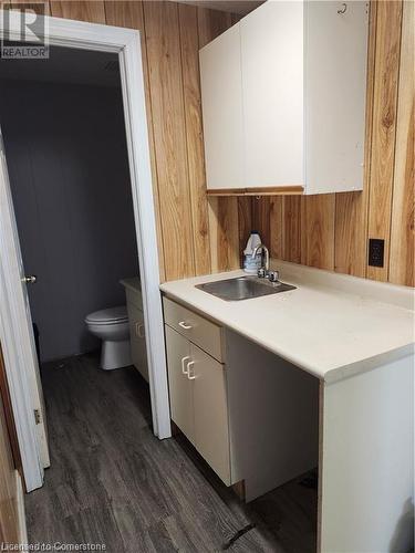 Bathroom with vanity, wooden walls, hardwood / wood-style flooring, and toilet - 26 Elmwood Avenue, Cambridge, ON 