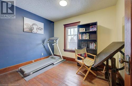 Exercise room featuring a textured ceiling and hardwood / wood-style floors - 97 Peppler Street, Waterloo, ON - Indoor Photo Showing Gym Room