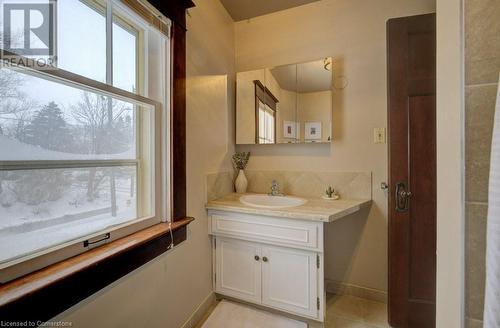 Bathroom with tile patterned flooring, tasteful backsplash, and vanity - 97 Peppler Street, Waterloo, ON - Indoor Photo Showing Bathroom